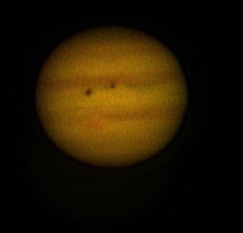 Transit of Jupiter by Callisto  By Phil Rourke. 9th February approx 22.30 UT. Callisto is seen to the right and its' shadow to the left in this picture. Telescope 8 inch reflector, Camera Philips Toucam Pro webcam exposure 1/33 second and 10 frames/ second, 1200 frames processed using Registax 4